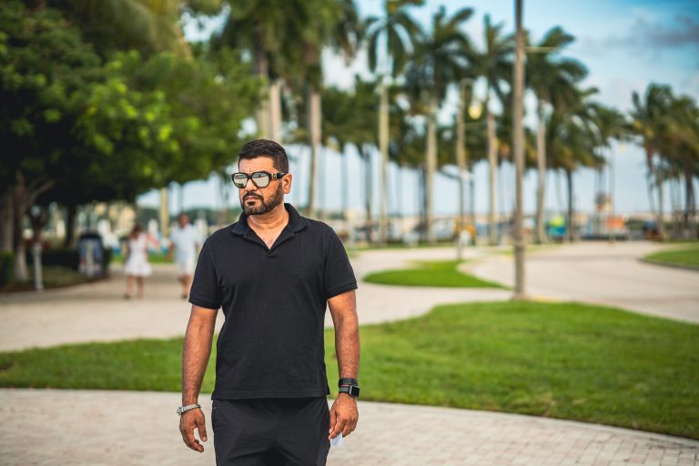 Man walking among palm trees, South Florida